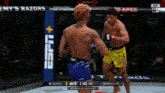 two men are fighting in a ufc ring with a espn logo in the corner