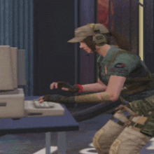 a woman wearing a hat and headphones looks at a computer screen