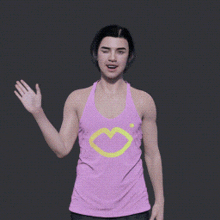 a girl wearing a pink tank top with a yellow heart on it