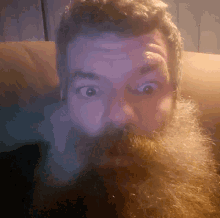 a man with a beard and mustache making a surprised face