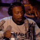 a man wearing headphones and a sweatshirt that says haps on it