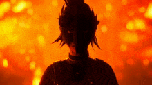 a silhouette of a person with a mask on their face in front of a fire background