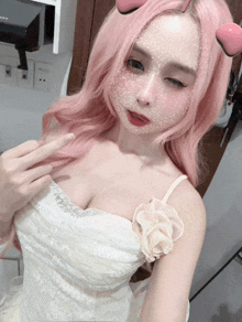 a woman with pink hair is wearing a white dress and a flower on her chest