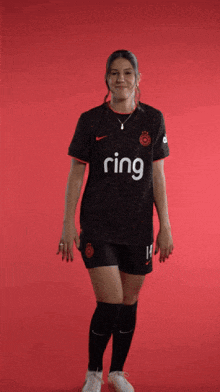a female soccer player wearing a jersey that says ring on it