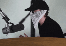 a man wearing a bandana and a hat with the letter j on it