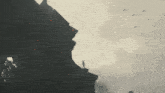 a silhouette of a building with birds flying in the background