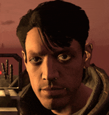 a close up of a man 's face in front of a red background