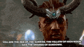 a man with horns on his head is talking about the red of the sunrise , the yellow of high noon and the orange of sundown