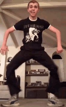 a man wearing a black shirt that says ' i 'm a dog ' on it is dancing in a living room