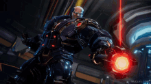 a video game character is holding a red object and muglife.com is on the bottom right