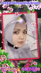 a picture of a woman in a hijab surrounded by flowers and the words assalamualaikum