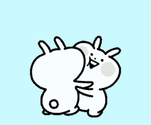 a couple of rabbits are hugging each other on a blue background
