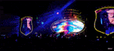 a crowd of people at a concert with a picture of a woman on the screen