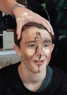 a young man with a drawing of a snake on his face