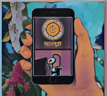 a hand is holding a cell phone with a cartoon on the screen that says the common coin show
