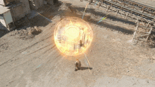 an aerial view of a man sitting in front of a glowing sphere