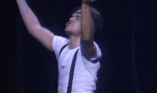 a man in a white shirt and suspenders is screaming