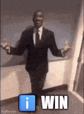 a man in a suit and tie is standing with his arms outstretched and the words i win behind him