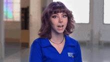a girl with purple hair is wearing a blue shirt that says best buy