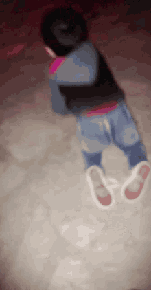 a blurry picture of a person laying on the ground with their feet in the air
