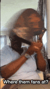 a woman brushing her hair with the words where them fans at on the bottom