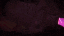 a close up of a purple light with a white light coming out of it