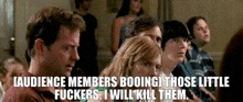 a group of people sitting in a room with a caption that says audience members booing