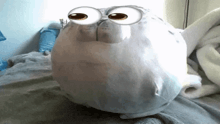 a stuffed animal that looks like a seal with big eyes