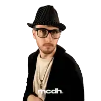 a man wearing glasses and a hat has the word mcdh on the bottom
