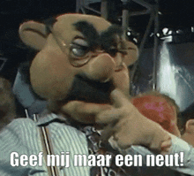 a puppet with glasses and a beard says geef mij maar een neut in a foreign language