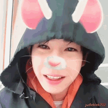 a close up of a person wearing a hooded jacket with mouse ears and a cat nose