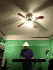 pld man beard hat ceiling fan playing piano
