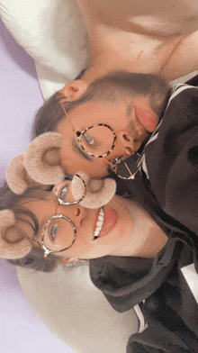 a man and a woman wearing fake teddy bear ears and glasses