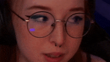 a close up of a woman wearing glasses and headphones