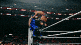 two wrestlers in a wrestling ring with the word raw on the walls