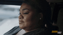 a woman in a car with shadow force written on the bottom right