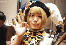 a girl in a jester costume giving a peace sign with the hashtag @ruuna_070