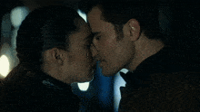 a man and a woman kissing with their eyes closed