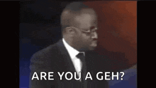 a man in a suit and tie is asking if he is a geh
