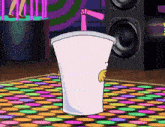 a cartoon character is standing on a colorful dance floor with a drink in it .