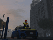 a woman sits on the hood of a blue and yellow audi