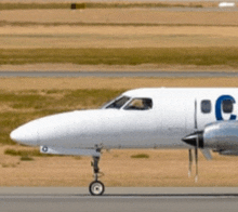 a small white plane with the letter c on the side
