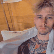 a man is sitting on a couch wearing a white robe