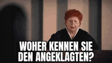 a woman with red hair and glasses is standing in front of a sign that says , woher kennen sie den angeklagten ?