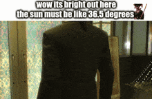 a man in a suit is standing in front of a sign that says wow its bright out here