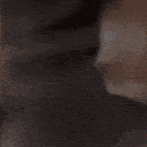 a close up of a person 's face with a shadow on the wall