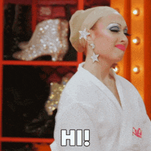 a woman in a white robe with the word hi on her chest