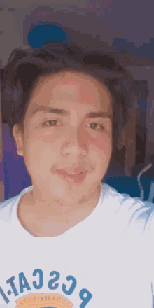 a man wearing a white t-shirt with the letters ta23 on it