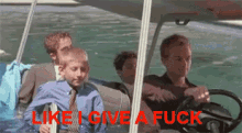 a man driving a golf cart with the words " like i give a fuck " written in red