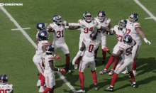 a group of new york giants football players are huddled together